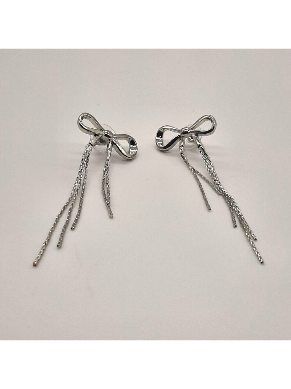 Urban Outfitters Sliver tone bow tie ribbons pierced earrings 80's Retro
